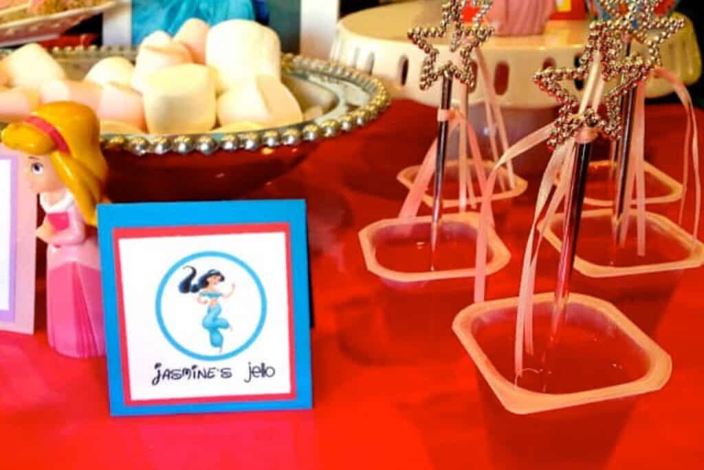 Jasmine's Jello with princess wands stuck in jello cups. The princess wands can then be party favors for the kids attending the princess party.