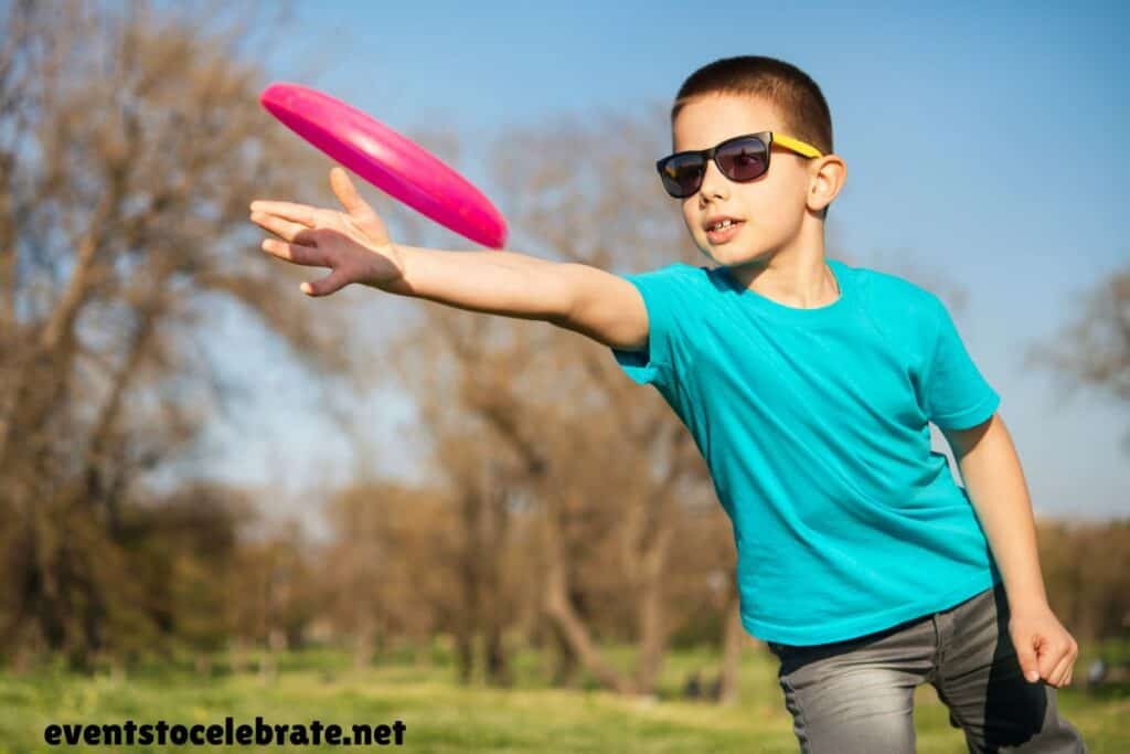 kid throwing a frisbee.