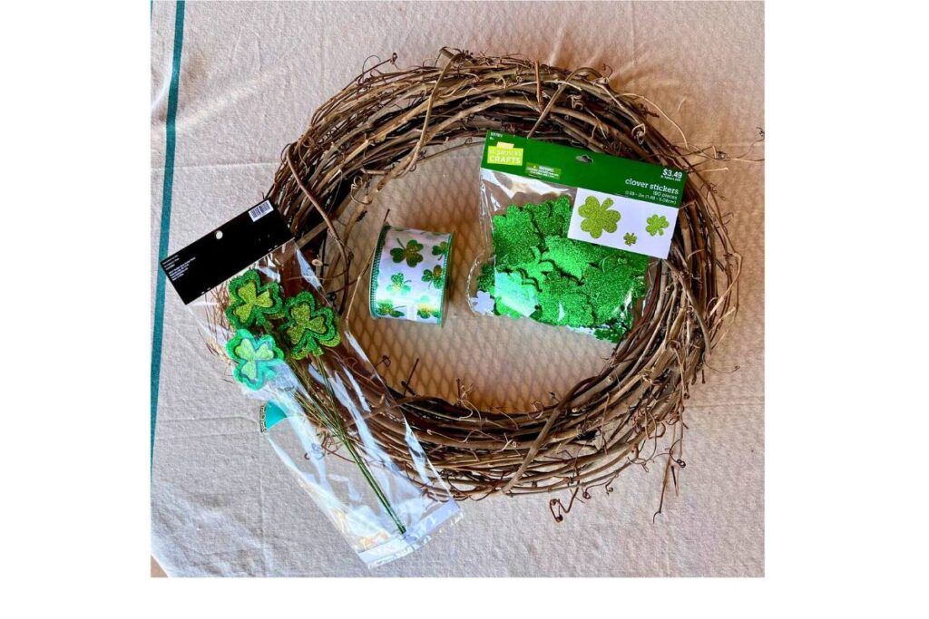 supplies needed to make the St. Patrick's day wreath which include a grapevine wreath ribbon and floral picks