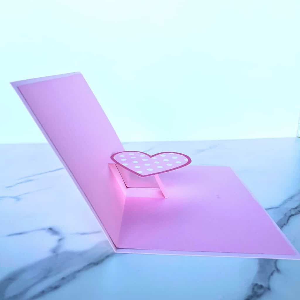 This image shows how the heart should be attached to the pop-up mechanism inside the card.