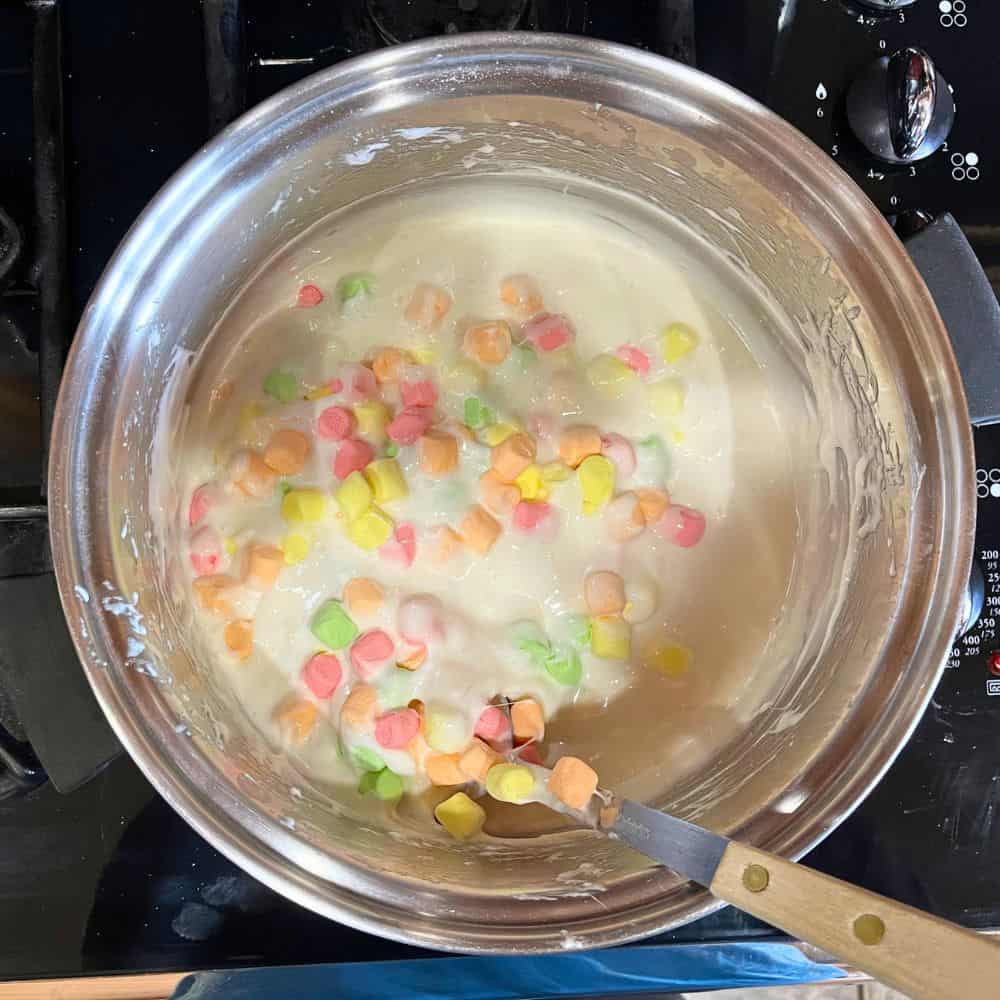 Adding pastel marshmallows to the unicorn party treats